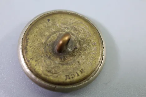 Original metal uniform button, also known as a livery button