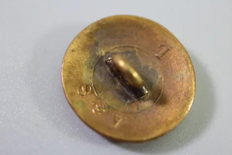 Original metal uniform button, also known as a livery button