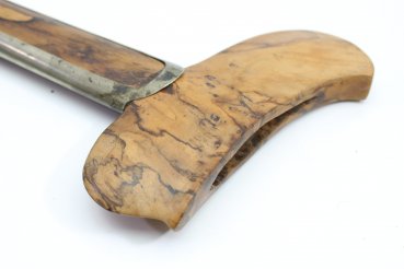 Java kris dagger with a straight flamed meteor iron blade and carved wooden handle.