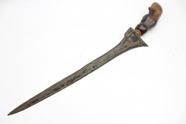 Java kris dagger with a straight flamed meteor iron blade and carved wooden handle.
