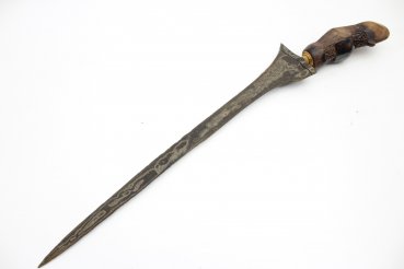 Java kris dagger with a straight flamed meteor iron blade and carved wooden handle.