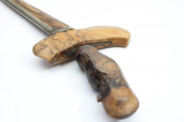 Java kris dagger with a straight flamed meteor iron blade and carved wooden handle.