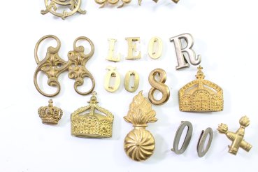 Discover a unique collection of 23 original uniform pieces, buttons, badges, overlays, and buckles