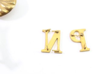 Discover a unique collection of 23 original uniform pieces, buttons, badges, overlays, and buckles