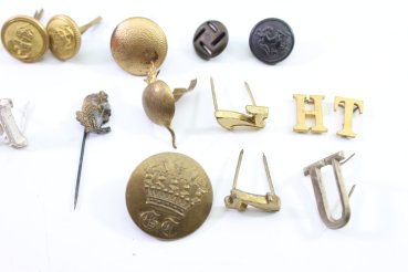 Discover a unique collection of 31 original uniform pieces, buttons, badges, overlays, and buckles