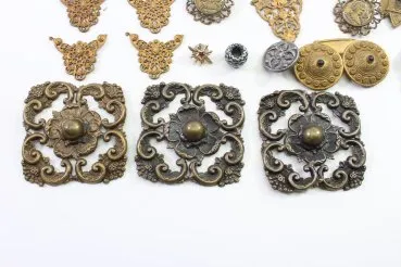 Discover a unique collection of 27 original uniform parts, buttons, badges, overlays, and buckles