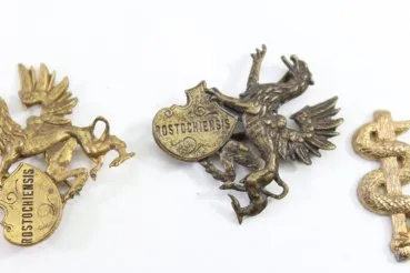 Discover a unique collection of 27 original uniform parts, buttons, badges, overlays, and buckles
