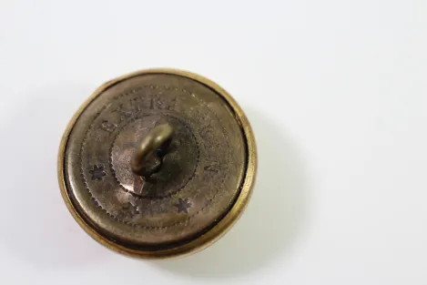 Metal buttons from a German uniform tailor, head uniform