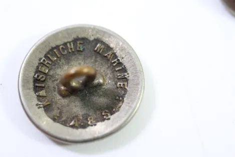 Metal buttons from a German uniform tailor, head uniform