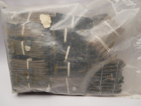 Original sealed bag containing NVA insignia – shoulder boards, buttons, rank stars, cords, etc.