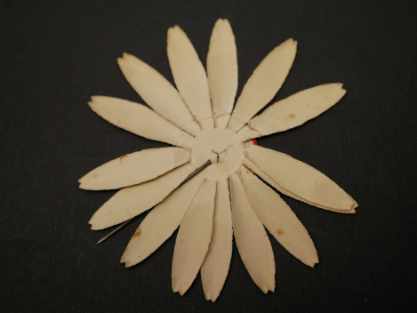 Paper badge – flower with swastika – Labor Day