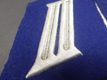 A pair of collar tabs, gun color blue from a tailor's estate