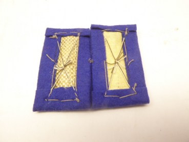 A pair of sleeve flaps, weapon color blue, from a tailor's estate