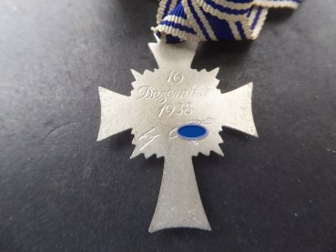 Mother's cross in silver on a ribbon