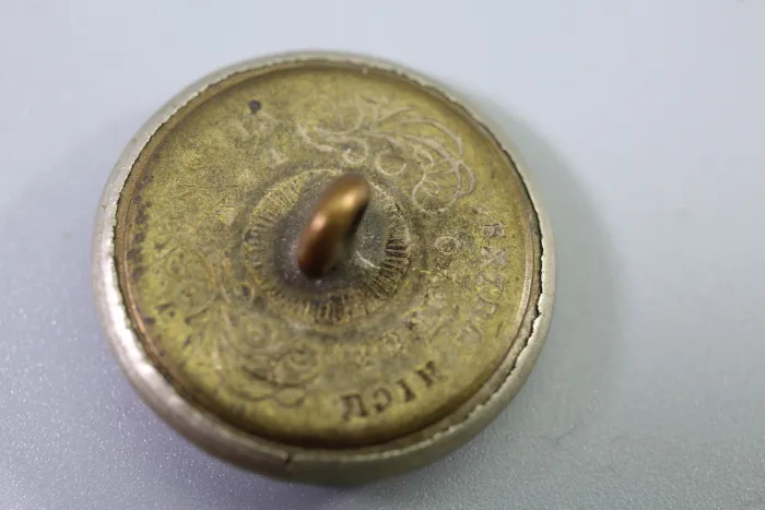 Original metal uniform button, also known as a livery button