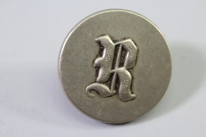 Original metal uniform button, also known as a livery button