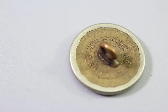 Original metal uniform button, also known as a livery button