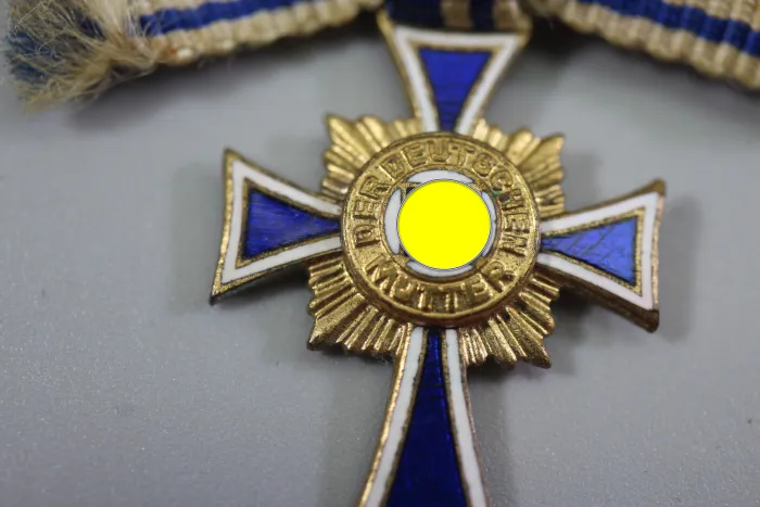 Miniature German Mother's Cross in Gold On ribbon bow; enamel undamaged.