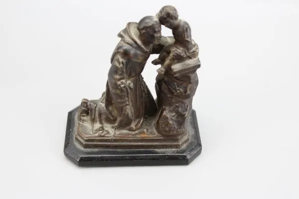 Ecclesiastical sculpture monk with child