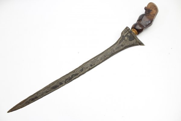 Java kris dagger with a straight flamed meteor iron blade and carved wooden handle.