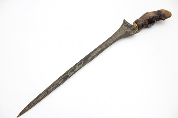 Java kris dagger with a straight flamed meteor iron blade and carved wooden handle.