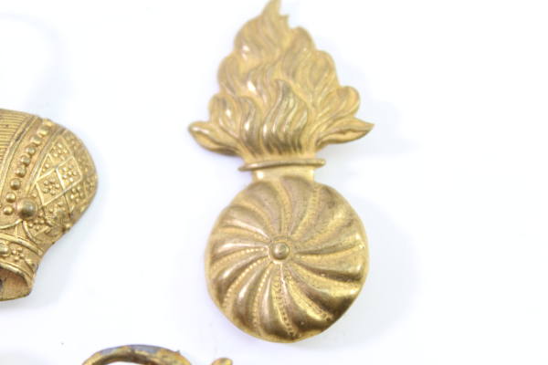 Discover a unique collection of 23 original uniform pieces, buttons, badges, overlays, and buckles