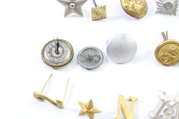 Discover a unique collection of 31 original uniform pieces, buttons, badges, overlays, and buckles