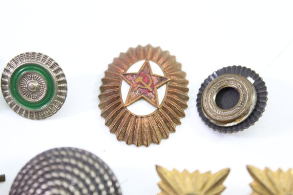 A set of 11 original uniform pieces, buttons, badges, overlays, and buckles