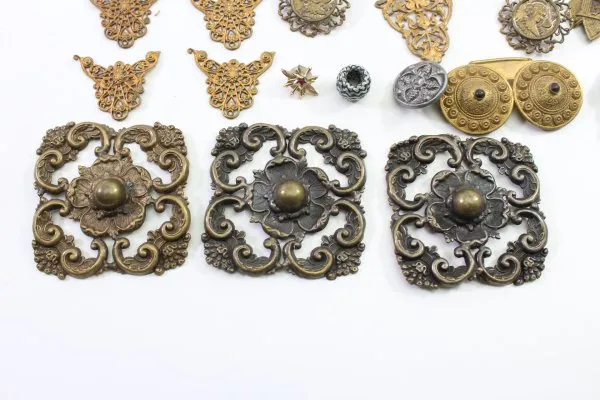 Discover a unique collection of 27 original uniform parts, buttons, badges, overlays, and buckles