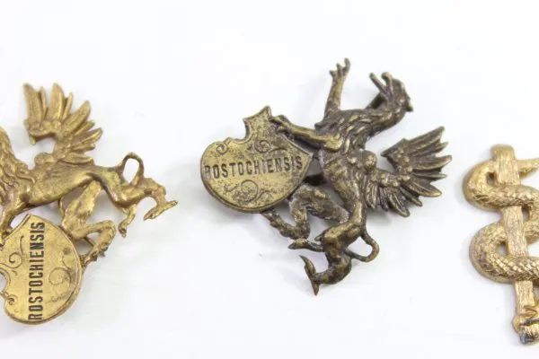 Discover a unique collection of 27 original uniform parts, buttons, badges, overlays, and buckles