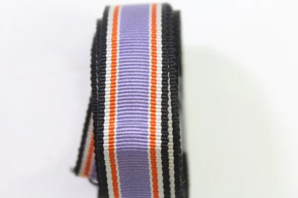 Discover a unique collection of 27 original uniform parts, buttons, badges, overlays, and buckles