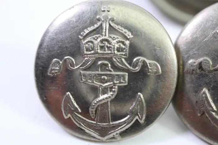 Metal buttons from a German uniform tailor, head uniform