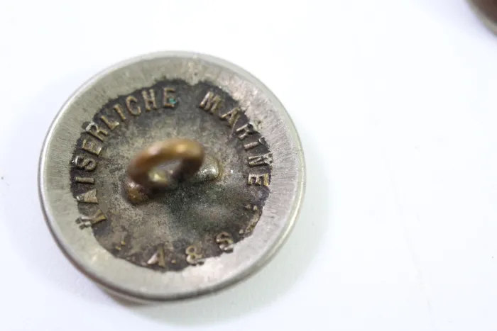 Metal buttons from a German uniform tailor, head uniform