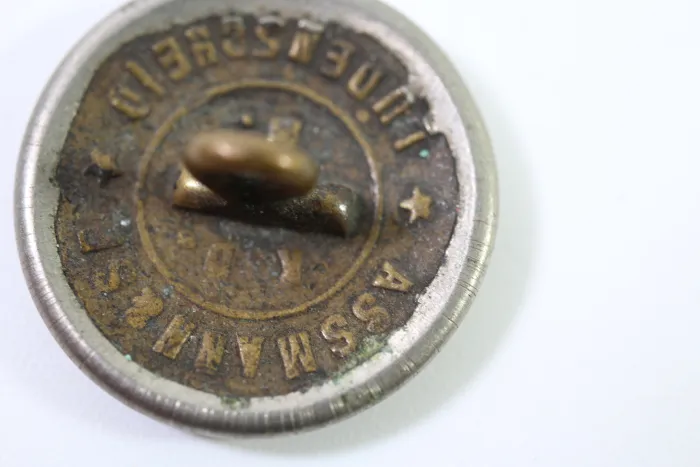 Metal buttons from a German uniform tailor, head uniform