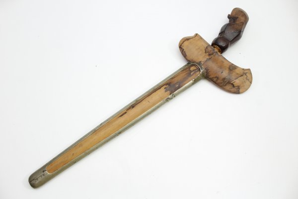 Java kris dagger with a straight flamed meteor iron blade and carved wooden handle.