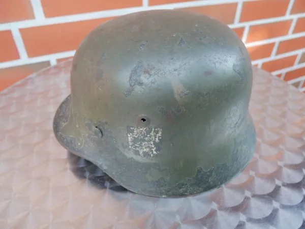 Wehrmacht steel helmet M 35 with two emblems and remains of camouflage