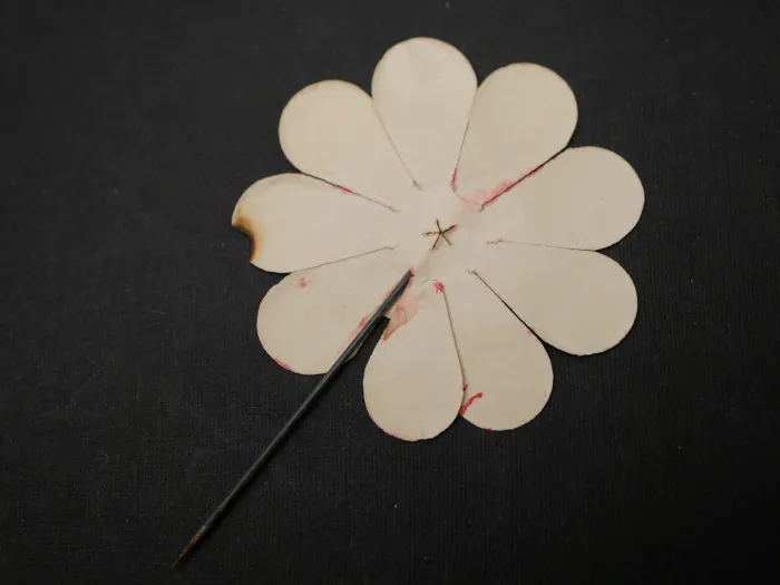 Paper badge – flower with swastika – Labor Day, with slip of paper