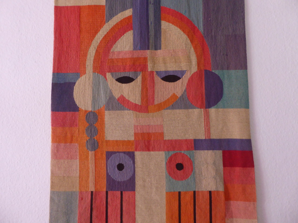 Bauhaus wall hanging / tapestry - geometrically arranged female body. (face + braids + breasts). Environment Grete Reichard