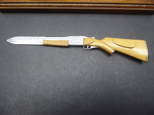 Gun shaped letter opener with stand