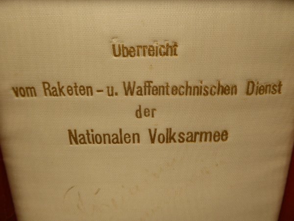Plaque in a case "Handed over by the Rocket and Weapons Technical Service of the National People's Army"