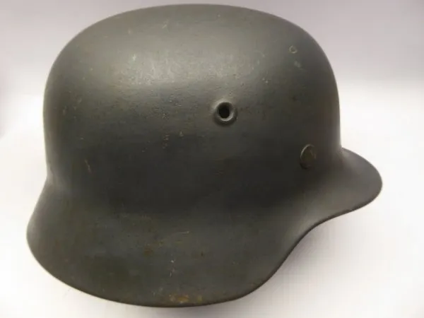 Stahlhelm M40 Luftwaffe Field Division with camouflage paint and a badge