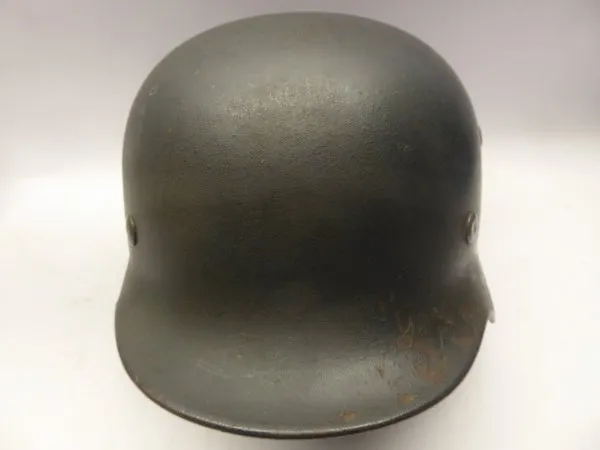 Stahlhelm M40 Luftwaffe Field Division with camouflage paint and a badge