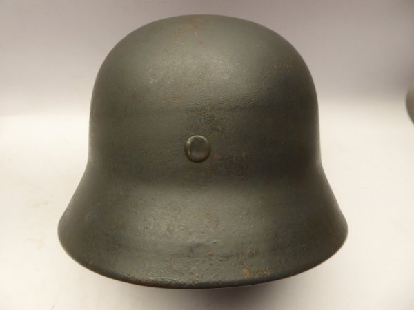 Stahlhelm M40 Luftwaffe Field Division with camouflage paint and a badge