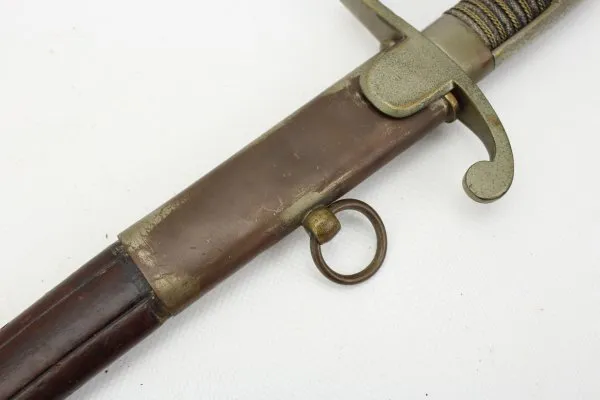 Officer's saber with blade etching in leather sheath.