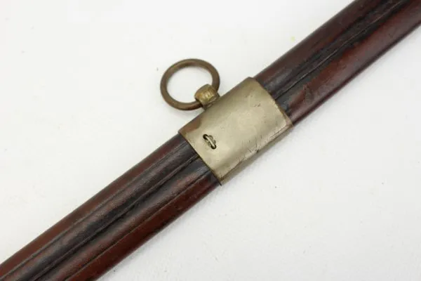 Officer's saber with blade etching in leather sheath.