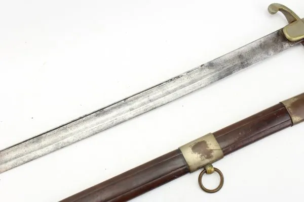 Officer's saber with blade etching in leather sheath.