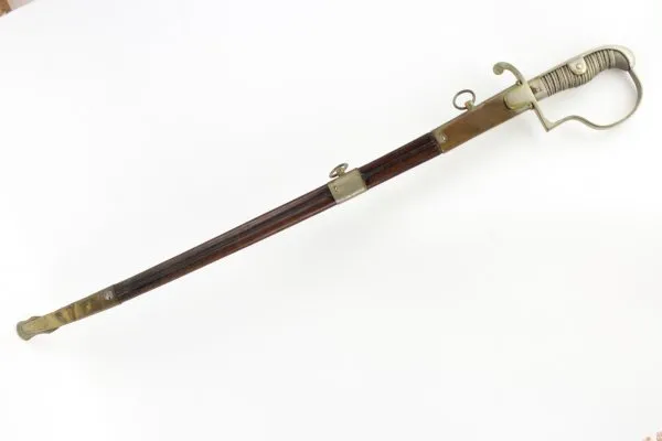 Officer's saber with blade etching in leather sheath.