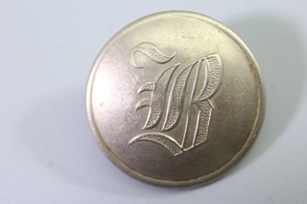 Original metal uniform button, also known as a livery button