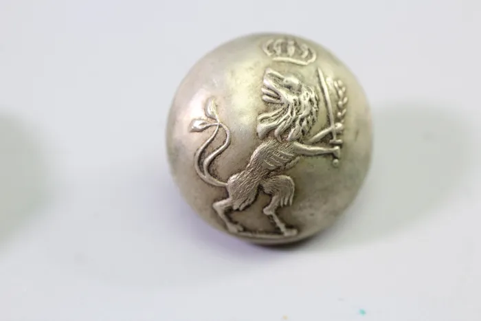 Original metal uniform button, also known as a livery button
