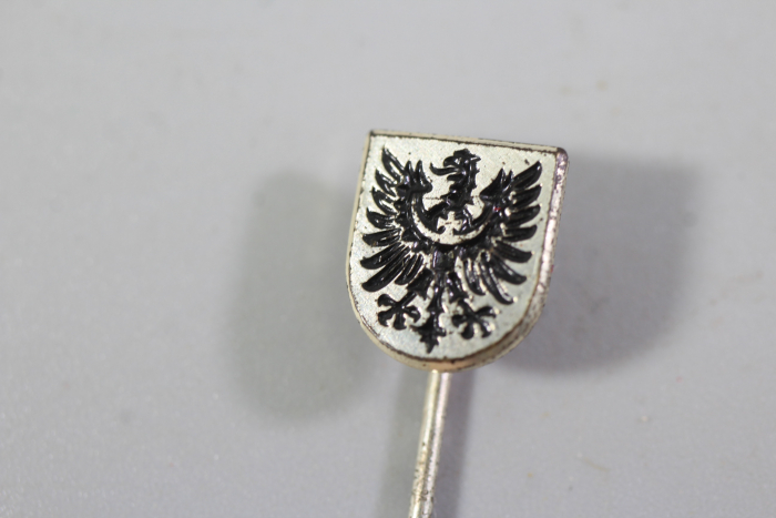 Navy lapel pin for the battleship Schlesien, bearing the manufacturer's name.